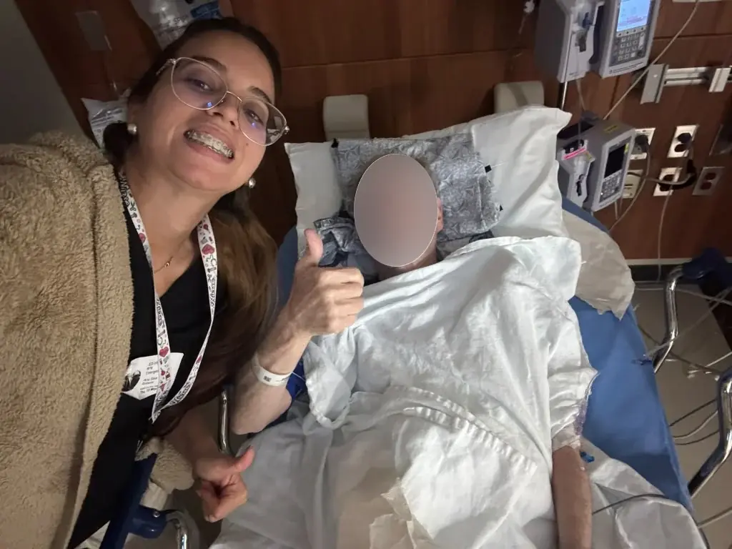Ana beside an older adult, whose face is obscured in the supplied photo